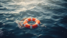 Safety Equipment. Orange Lifebuoy In The Blue Sea