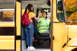 © Prostock-studio - Cheerful little girl giving high five to smiling school bus female driver
