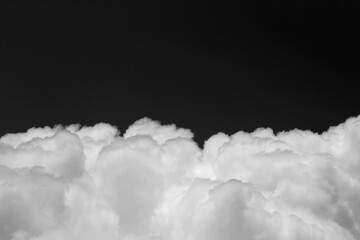 Wall Mural - clouds over black background .
