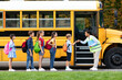 © Prostock-studio - Friendly teacher lady fist bumping with kids as they boarding school bus