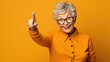 © MP Studio - Senior woman wearing casual clothes pointing with hand and finger to the side looking at the camera.