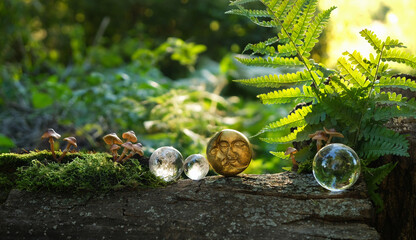 Wall Mural - moon amulet and crystal balls on tree stump in forest, abstract natural background. esoteric spiritual ritual, wiccan magic, witchcraft. fairytale, mystery atmosphere. moon esbat, harvest moon symbol