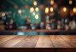 Bar or pub with a blurred background and an empty wooden table. For the purpose of product display