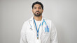 © Krakenimages.com - African american man doctor standing with serious expression over isolated white background