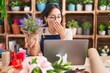 © Krakenimages.com - Young hispanic woman working at florist shop doing video call bored yawning tired covering mouth with hand. restless and sleepiness.