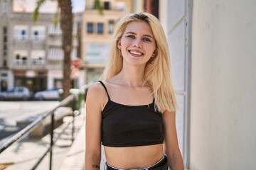 Poster - Young blonde woman smiling confident standing at street