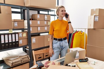 Poster - Young blonde woman ecommerce business worker talking on smartphone standing at office