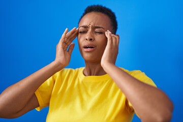 Sticker - African american woman suffering for headache crying over isolated blue background