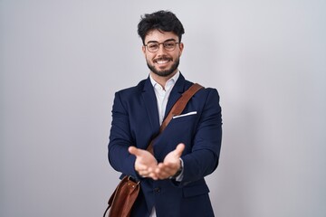 Poster - Hispanic man with beard wearing business clothes smiling with hands palms together receiving or giving gesture. hold and protection