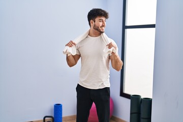 Sticker - Young hispanic man smiling confident holding towel at sport center