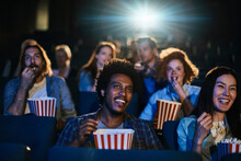 Young And Diverse Group Of Friends Watching A Movie In The Movie Theater