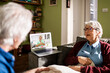 © Marko Geber - Senior Caucasian couple consulting their doctor on a video call on the laptop at home
