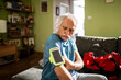 © Marko Geber - Senior man preparing his smartphone armband before going out for a jog