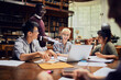 © Marko Geber - Young and diverse group of students working on a assignment together in the university library