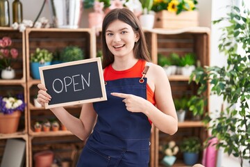 Sticker - Young caucasian woman working at florist holding open sign smiling happy pointing with hand and finger