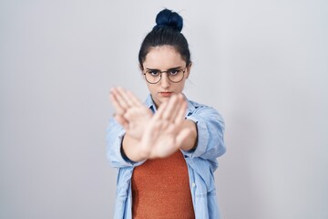 Poster - Young modern girl with blue hair standing over white background rejection expression crossing arms and palms doing negative sign, angry face