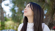 © Krakenimages.com - Young chinese woman looking to the sky with serious expression at park