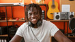 © Krakenimages.com - African american man musician wearing headphones smiling confident at music studio