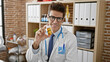 © Krakenimages.com - Young hispanic man doctor holding bottle of pills at the clinic