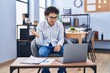 © Krakenimages.com - Hispanic man doing video call waving to laptop celebrating achievement with happy smile and winner expression with raised hand