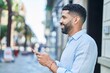 © Krakenimages.com - Young arab man smiling confident using smartphone at street