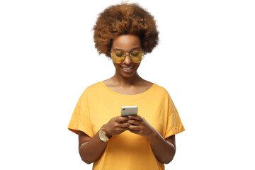 African american woman standing, looking at screen of phone, surfing web and smiling while browsing content