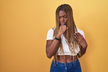 Wall Mural - African american woman with braided hair standing over yellow background feeling unwell and coughing as symptom for cold or bronchitis. health care concept.