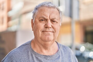 Poster - Middle age grey-haired man standing with relaxed expression at street