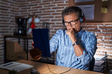 Sticker - Middle age hispanic man using touchpad sitting on the table at night feeling unwell and coughing as symptom for cold or bronchitis. health care concept.