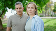 © Krakenimages.com - Man and woman couple standing together with serious face at park