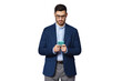 © Damir Khabirov - Serious young businessman wearing blue suit, looking at phone screen, chatting online, surfing the internet