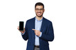 Young businessman showing blank phone screen and pointing to it with finger, copy space for your app