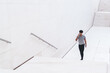 © BullRun - Stylish male with phone in white urban passage