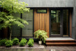 Main entrance door. Japanese, minimalist style exterior of villa. Black panel walls and timber wood lining front door. Back yard with beautiful landscape design.