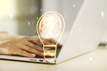 Poster - Creative light bulb with human brain hologram and with hands typing on computer keyboard on background, artificial Intelligence and neural networks concept. Multiexposure