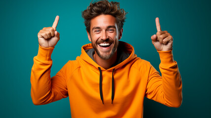 young handsome man with beard wearing winter jacket and sunglasses over isolated background very happy and excited for winner expression with arms raised, smiling and screaming for