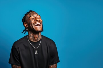 Poster - Young man with neck and face tattoos smiling happy face laughing