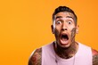Young man with neck and face tattoos shocked reaction face