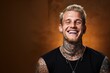 Young man with face and neck tattoos smile happy face