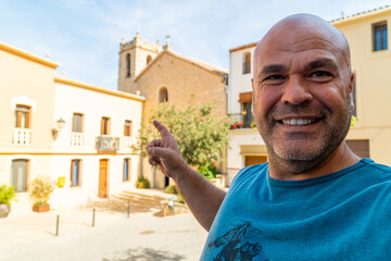 Wall Mural - Smiling man takes a selfie in the old town