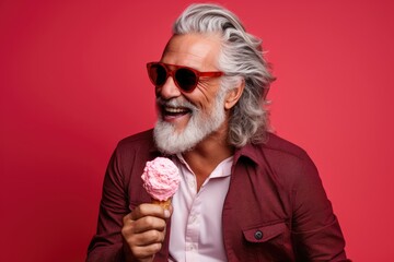 A stylish and confident senior gentleman with a beard, exuding joy and positivity in a modern and trendy fashion portrait with ice cream.