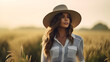 © Design Council - Portrait of a female farmer wearing overalls and a straw hat, standing in the middle of a green wheat field during sunrise Agriculture