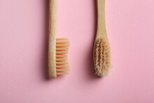 Two Bamboo Toothbrushes On Pink Background, Flat Lay