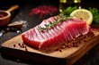 Raw tuna steak on a cutting board with rosemary and pepper, closeup view of a fresh raw tuna steak on cutting, AI Generated