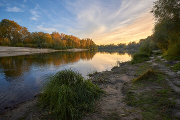 Wall Mural - autumn landscape with river and forest at the sunset