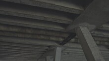 View Of Large Grey Concrete Bridge Structure From Below At Daytime. Cement Abutments And Stanchions Support Beam Bridge Superstructure