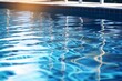 © vachom - Blue water surface in swimming pool with sun reflections. Abstract background.