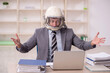 © Elnur - Young male employee wearing spacesuit in the office