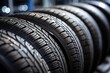 Brand new winter tires on display at an auto repair service center with a modern tread design isolated in a close up shot The background showcases a stack of t