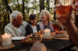 © bernardbodo - Family eating croissants, baguettes and fruit at picnic
